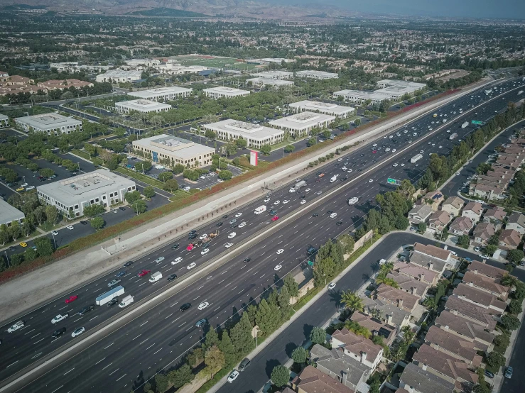 an aerial view of a highway in a city, by Ryan Pancoast, city of industry, background image, commercial photo