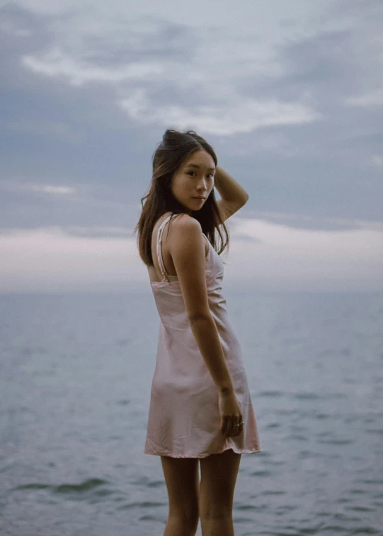 a woman standing in front of a body of water, pastel pink skin tone, a young asian woman, overlooking the ocean, 5 0 0 px models