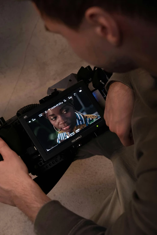 a close up of a person holding a camera, inspired by Steve McCurry, video art, on set, sony a 7 s, full screen, crawling towards the camera