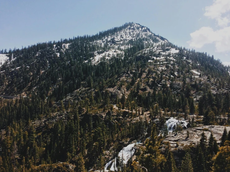 a mountain with a waterfall in the middle of it, by Ryan Pancoast, unsplash contest winner, snow on trees and ground, central california, wide high angle view, 90s photo