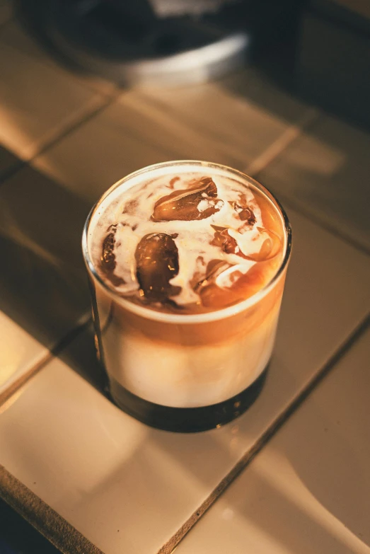 a cup of coffee sitting on top of a counter, iced latte, detailed product image, spirits, multiple stories