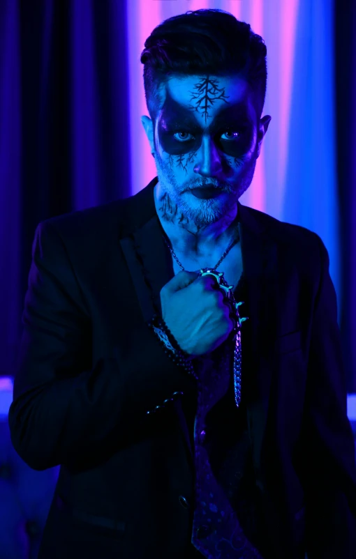 a close up of a person in a suit and tie, an album cover, inspired by James Bolivar Manson, international gothic, blue body paint, tattooed man, slide show, movie photo