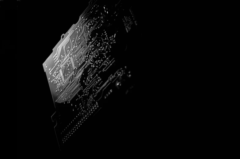 a black and white photo of a circuit board, by Emma Andijewska, pexels, computer art, background image, solid black background, graphics card, artistic 4 k