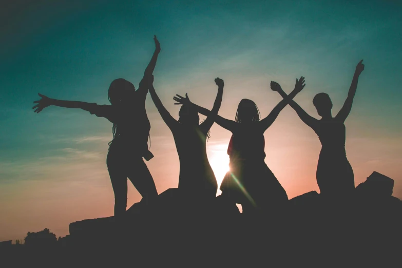 a group of people standing on top of a rock, during a sunset, profile image, college girls, dancing with each other