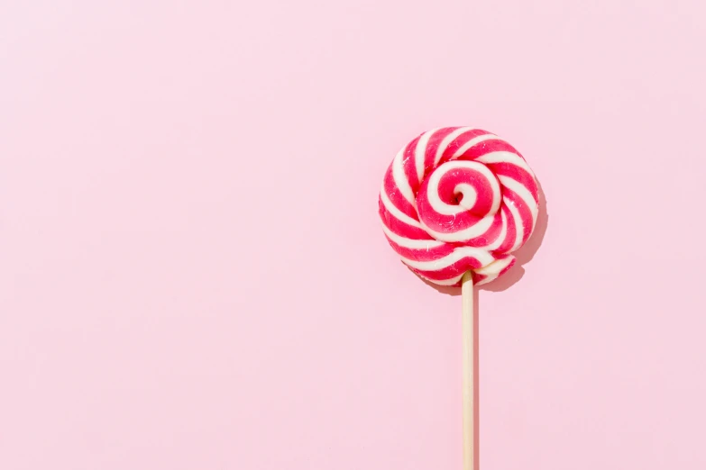 a pink lollipop on a stick against a pink background, by Matthias Weischer, pexels, red and white stripes, 🐿🍸🍋, on a canva, spiral