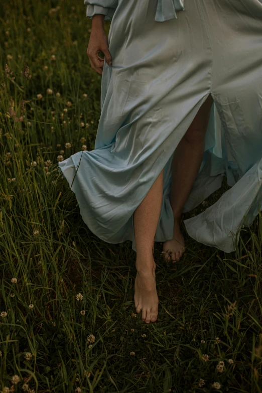 a woman in a blue dress standing in a field, an album cover, inspired by Elsa Bleda, unsplash, renaissance, exposed toes, nightgown, detail shot, ignant