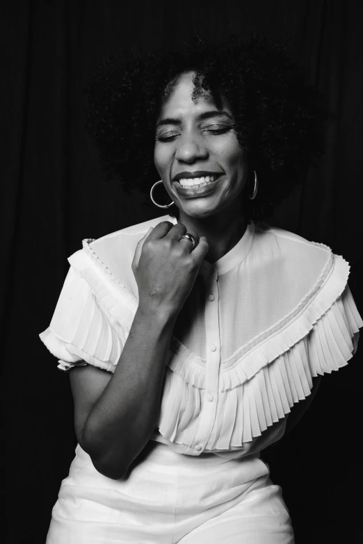 a black and white photo of a woman smiling, pexels contest winner, black arts movement, white backdrop, musician, medium format. soft light, various posed