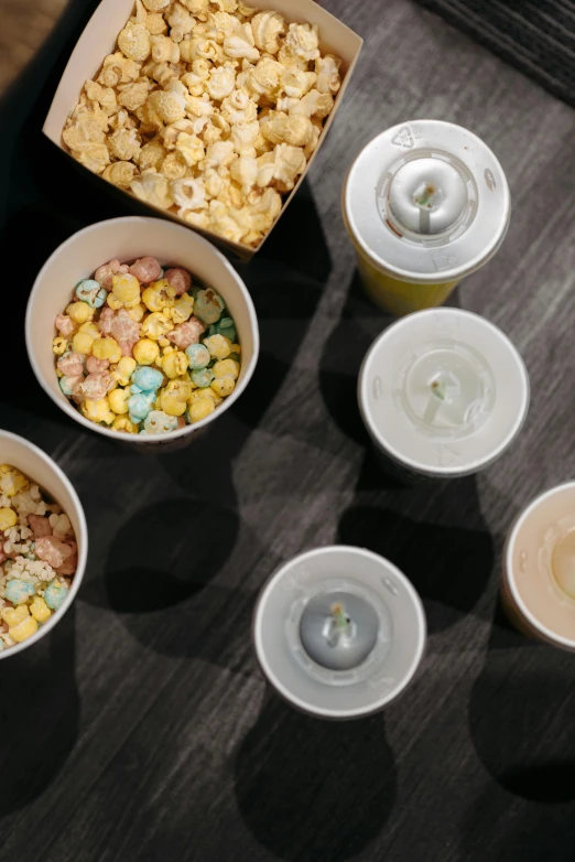 a couple of cups sitting on top of a table, a table full of candy, imax, birdseye view, cheerios