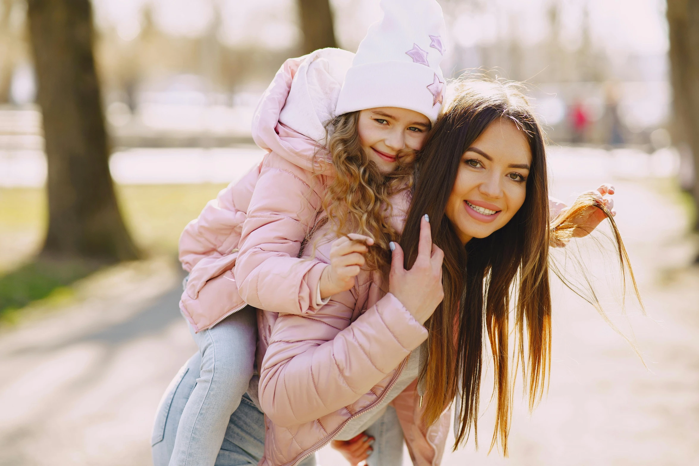 a woman holding a little girl in her arms, pexels contest winner, wearing a pastel pink hoodie, avatar image, beautiful girls, thumbnail