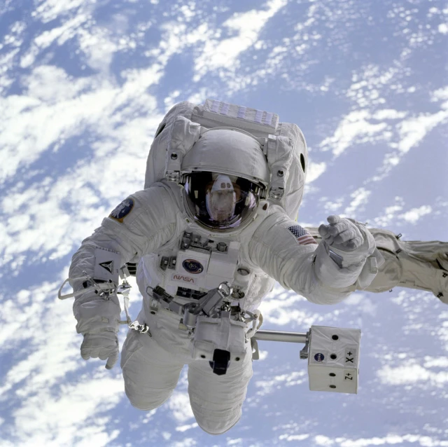 a man in a space suit flying through the air, nasa canadarm, looking off into the distance, from 2001, star walk