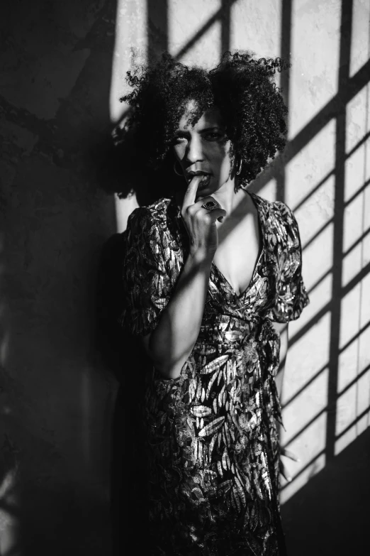 a black and white photo of a woman in a dress, inspired by Gordon Parks, curly haired, high contrast dappled lighting, photograph taken in 2 0 2 0, medium format. soft light