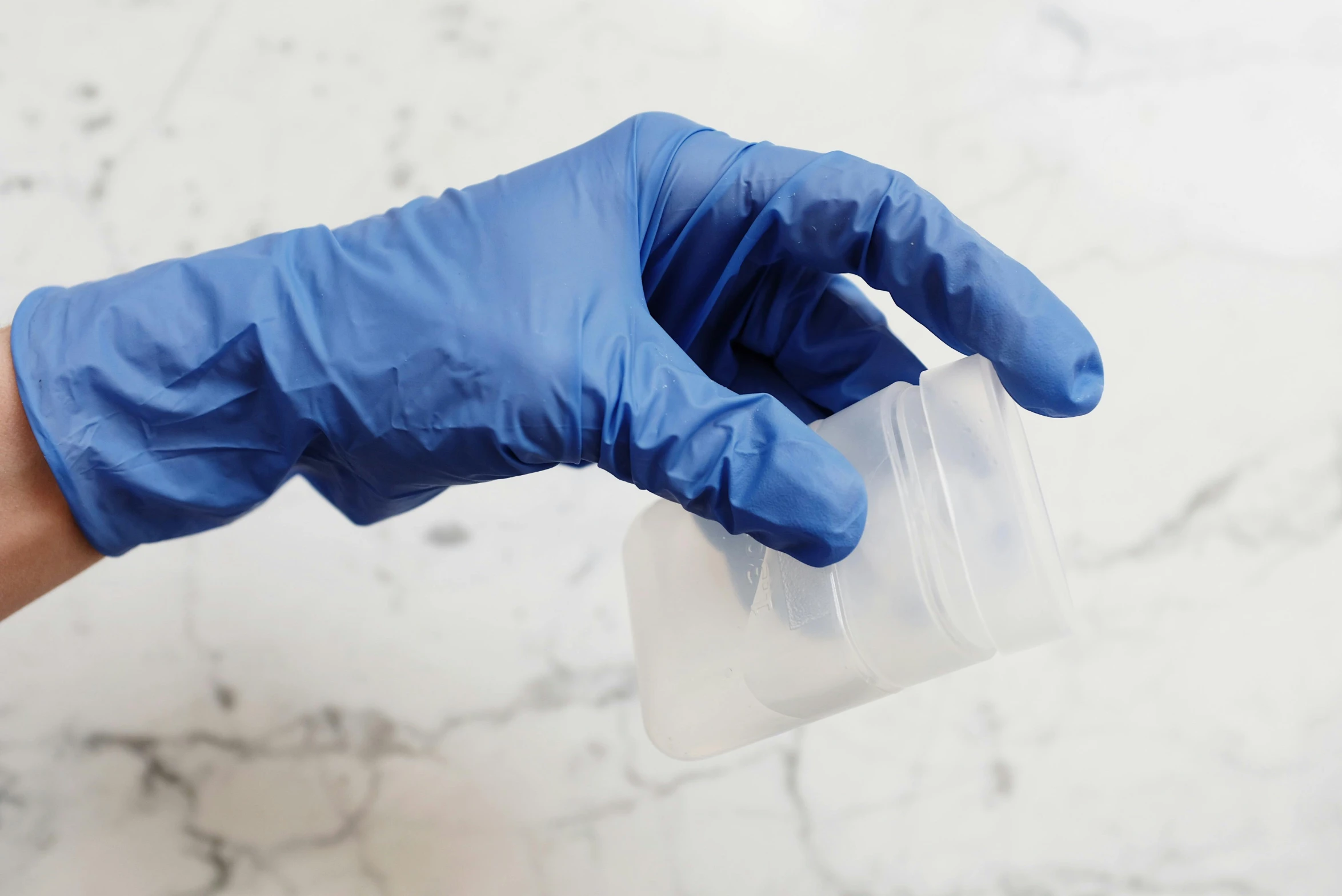 a person in blue gloves holding a plastic container, unsplash, marble material, made of lab tissue, silicone cover, high samples
