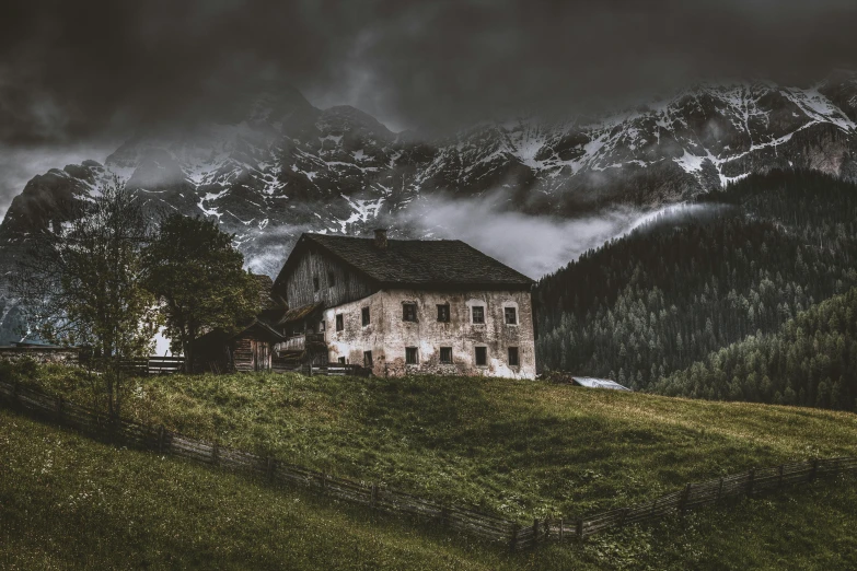 a house sitting on top of a lush green hillside, a matte painting, by Sebastian Spreng, pexels contest winner, extremely gloomy lighting, old cabin, dolomites, stormy night