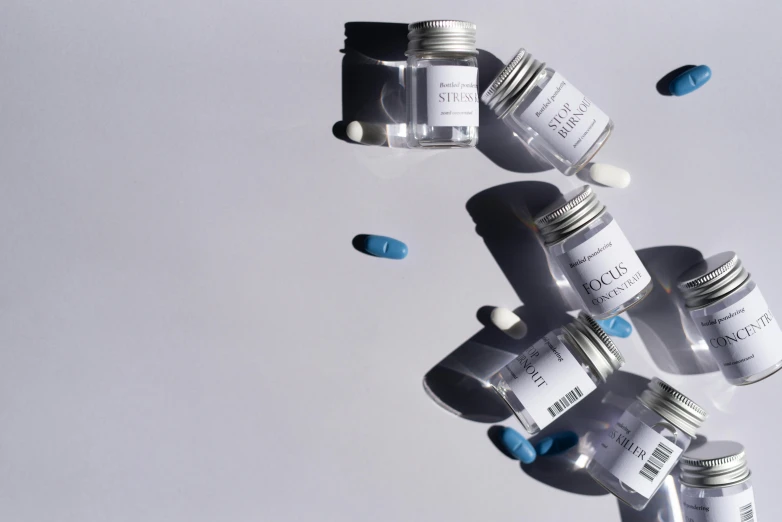 a bunch of pills sitting on top of a table, by Sebastian Vrancx, unsplash, photorealism, photoshoot for skincare brand, blue tint ektachrome film, on grey background, off - white collection