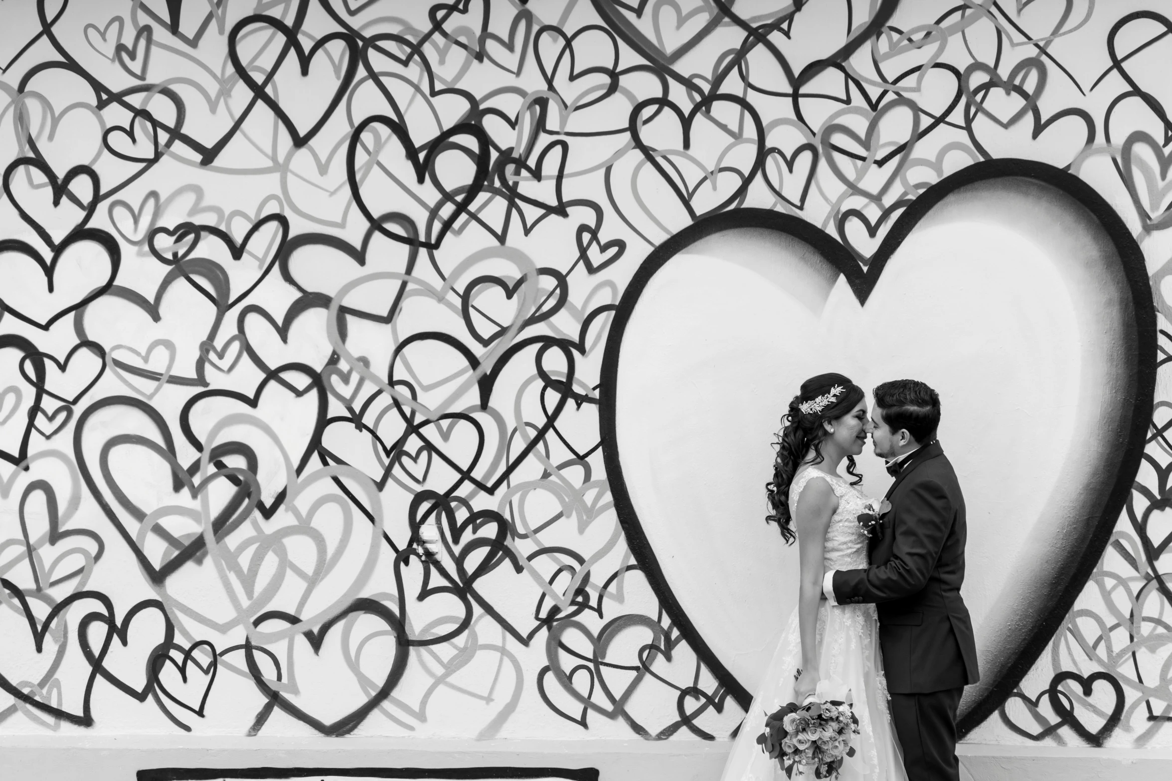 a black and white photo of a bride and groom, by Ke Jiusi, pexels, process art, mural art, hearts, monochrome color, infinity