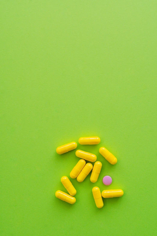 yellow and pink pills on a green background, a digital rendering, by Sven Erixson, pexels, instagram picture, yellow purple green black, minimal composition, 15081959 21121991 01012000 4k