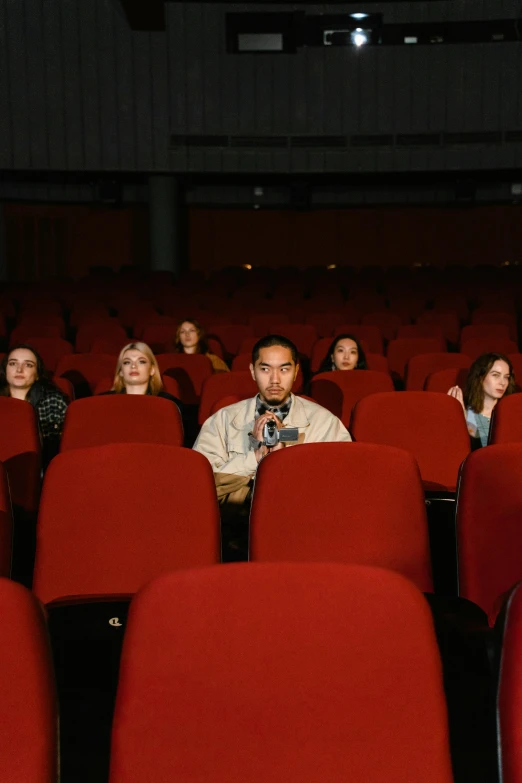 a group of people sitting in a movie theater, hyperrealism, [ theatrical ], [ cinematic, squad, foreground
