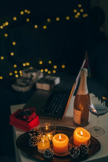 a laptop computer sitting on top of a desk next to candles, pexels contest winner, romanticism, drinking champagne, profile pic, winter, lo fi