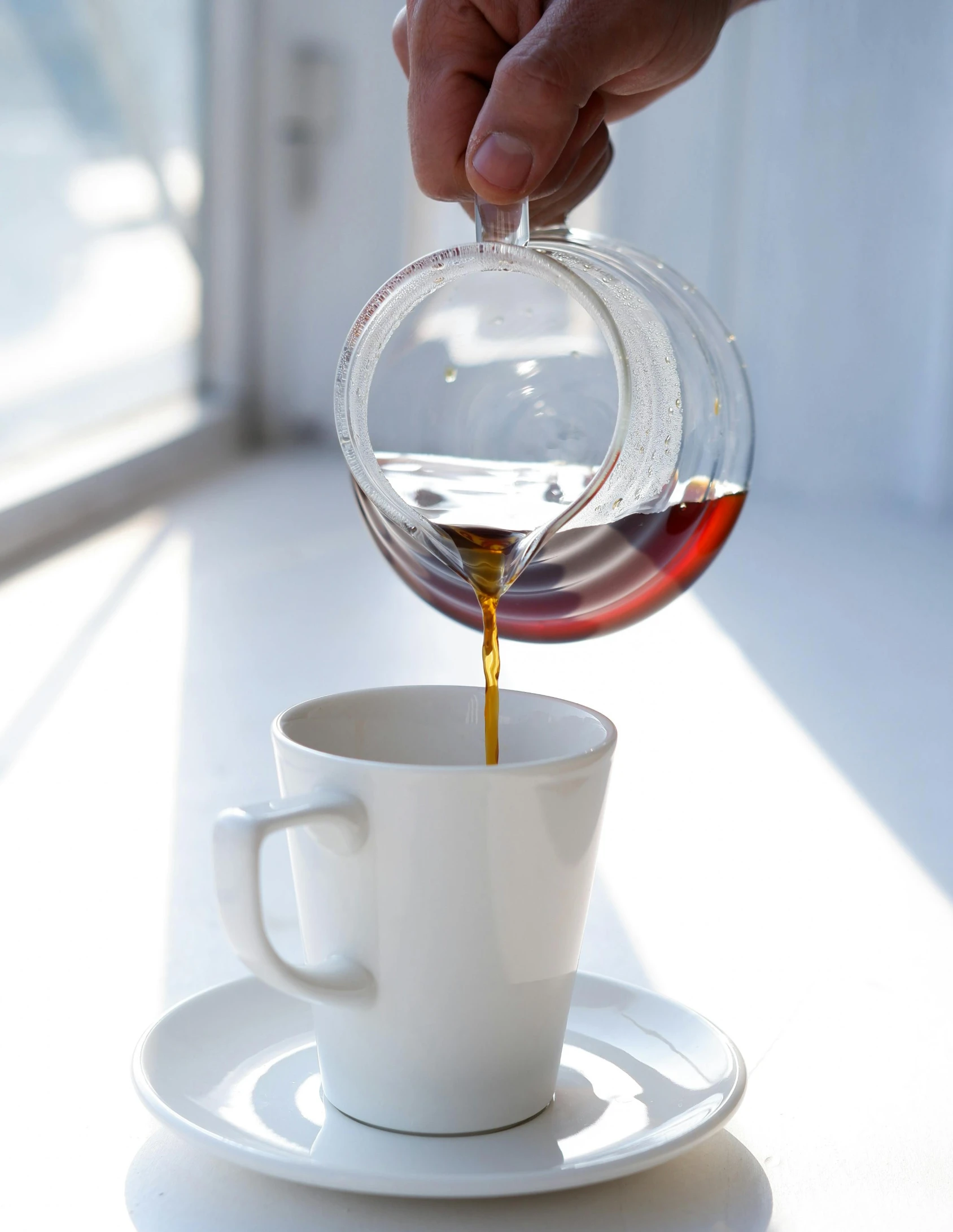 a person pouring coffee into a cup on a saucer, profile image