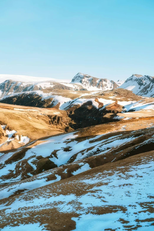 a person standing on top of a snow covered mountain, les nabis, rolling foothills, golden grasslands, slide show, lush valley