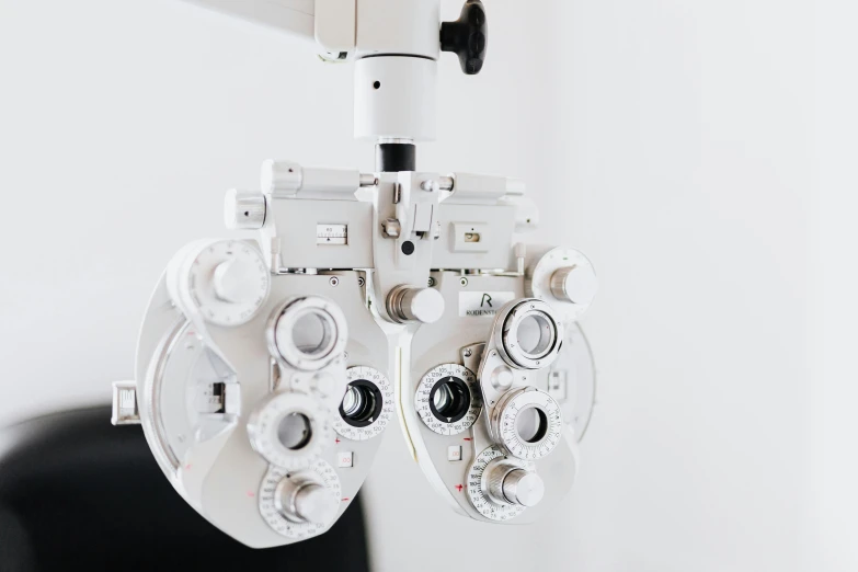 a close up of a pair of eye glasses, by Adam Marczyński, unsplash, hyperrealism, medical machinery, with a white background, clinical, high fov