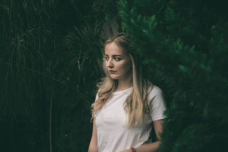 a woman standing in front of a tree, inspired by Elsa Bleda, pexels contest winner, portrait of white teenage girl, dressed in a white t shirt, blonde women, avatar image
