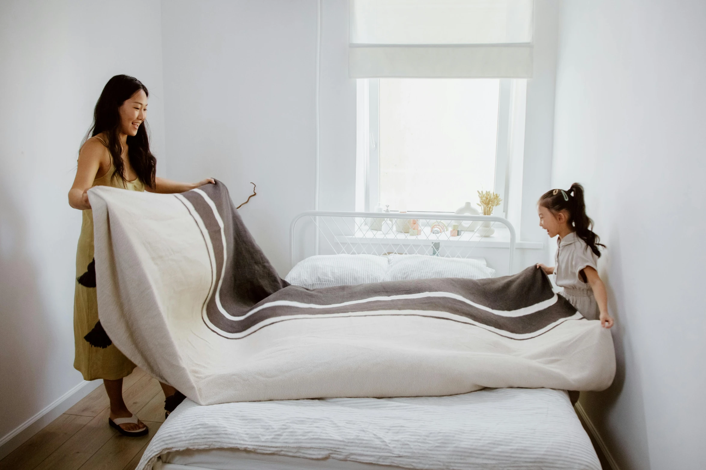 a woman standing next to a little girl on a bed, inspired by Wang Duo, unsplash, arabesque, giant snake, lined in cotton, natural and organic and flowing, angled view