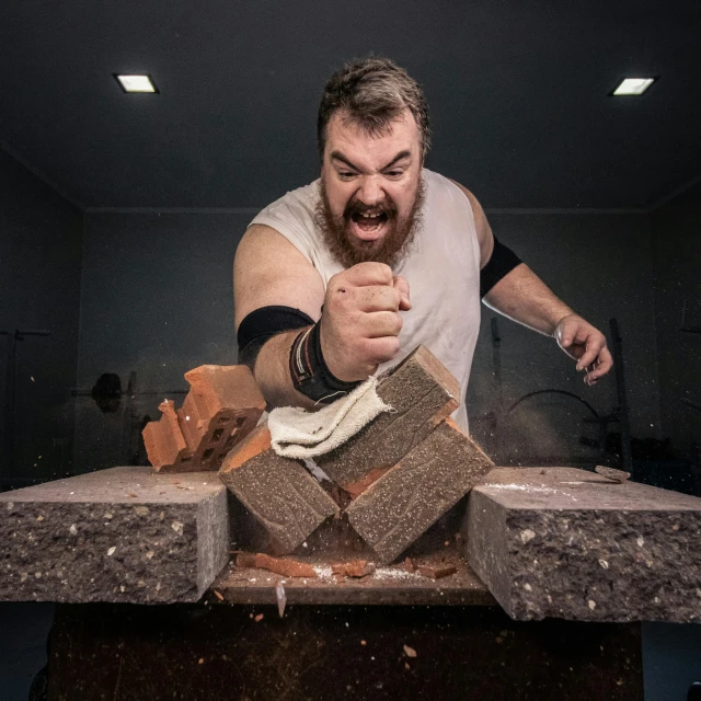 a man that has a hammer in his hand, an album cover, inspired by Adriaen Hanneman, pexels contest winner, auto-destructive art, athletic crossfit build, thrown tables, wide angle studio shoot, cinder blocks