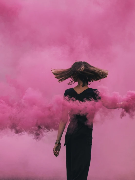 a woman standing in front of a cloud of pink smoke, pexels contest winner, hot pink and black, ((pink)), smoke grenade, in style of joel meyerowitz