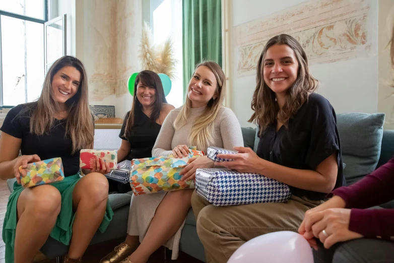 a group of women sitting on top of a couch, by Emma Andijewska, pexels contest winner, happening, birthday wrapped presents, avatar image, maternity feeling, at a birthday party