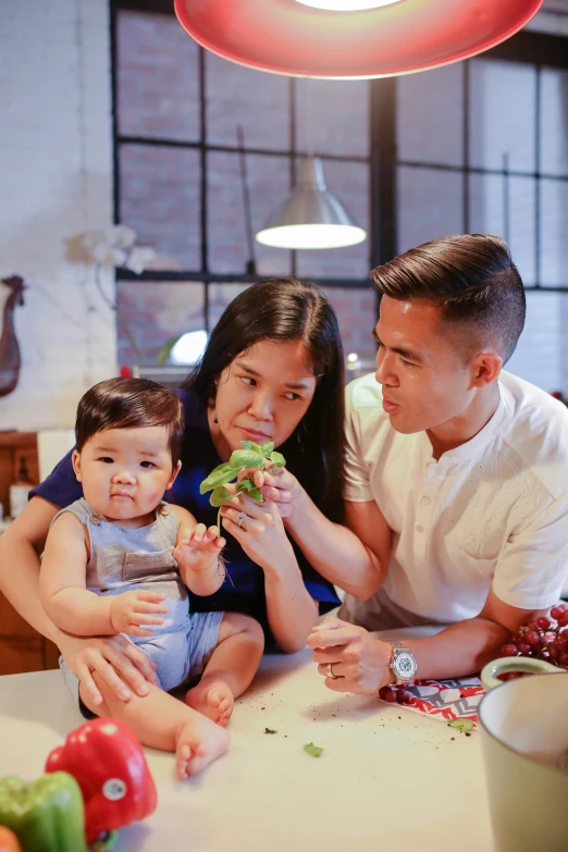 a man and woman sitting at a table with a baby, pexels contest winner, confident holding vegetables, asian male, gif, profile image