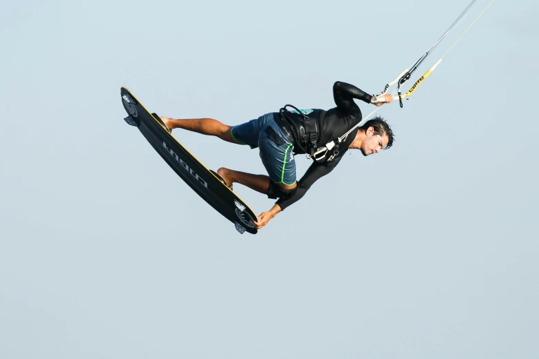 a man flying through the air while riding a surfboard, profile image, kites, looking towards the camera, ross tan
