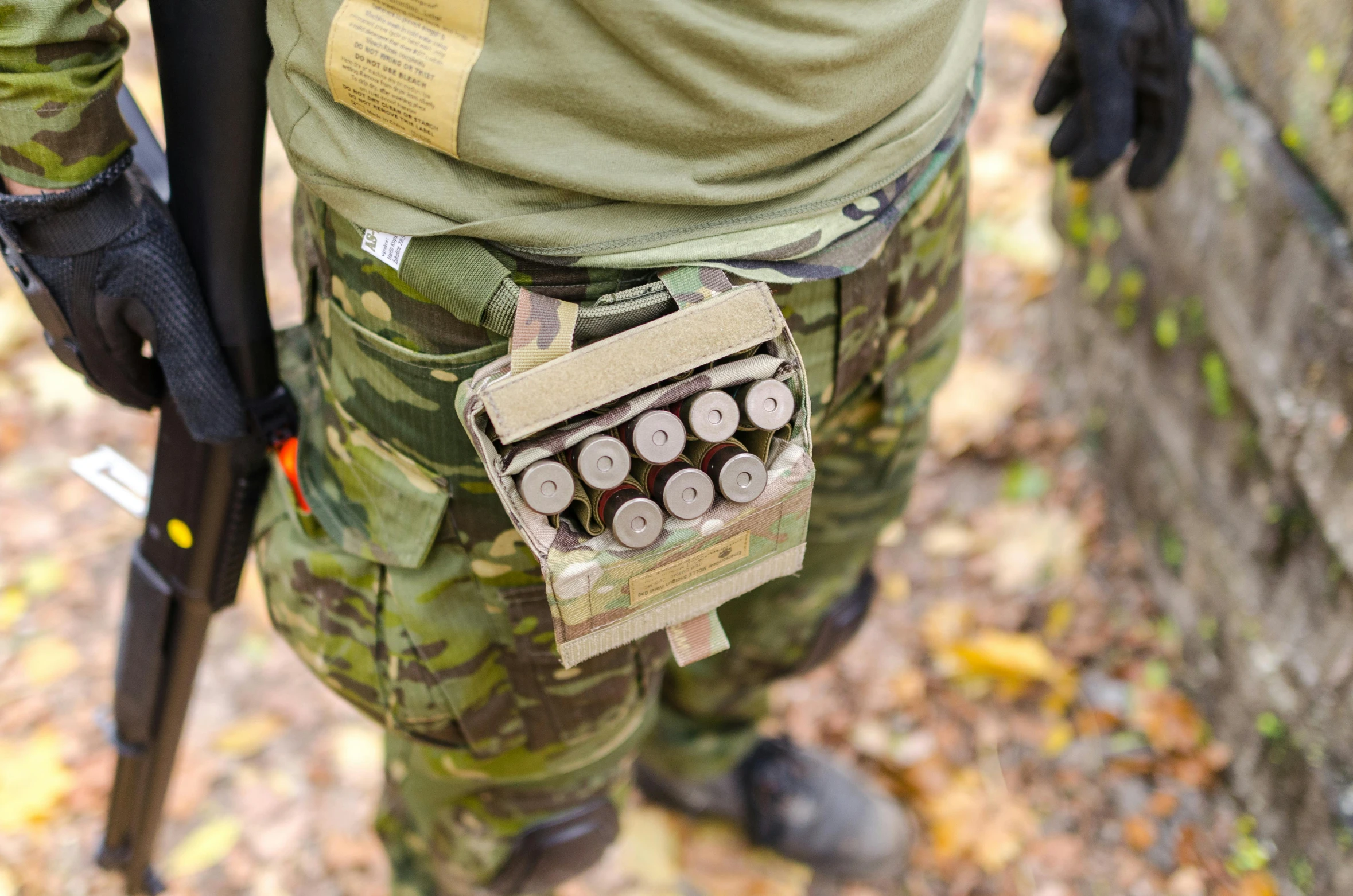 a close up of a person with a gun, ammo bandolier, level 1 plate armour, woodland, 6 pack