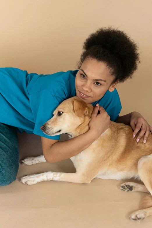 a woman sitting on the floor with a dog, healthcare worker, back arched, caramel, headshot