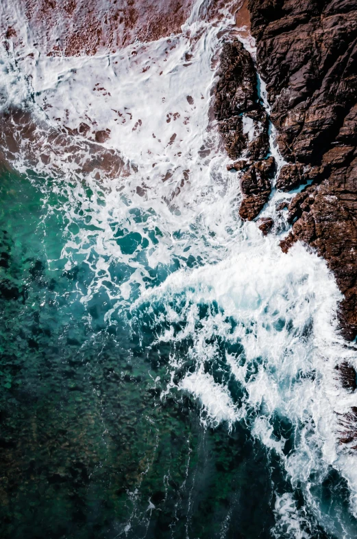 a large body of water next to a rocky shore, pexels contest winner, happening, close-up from above, charybdis, full frame image, awards winning