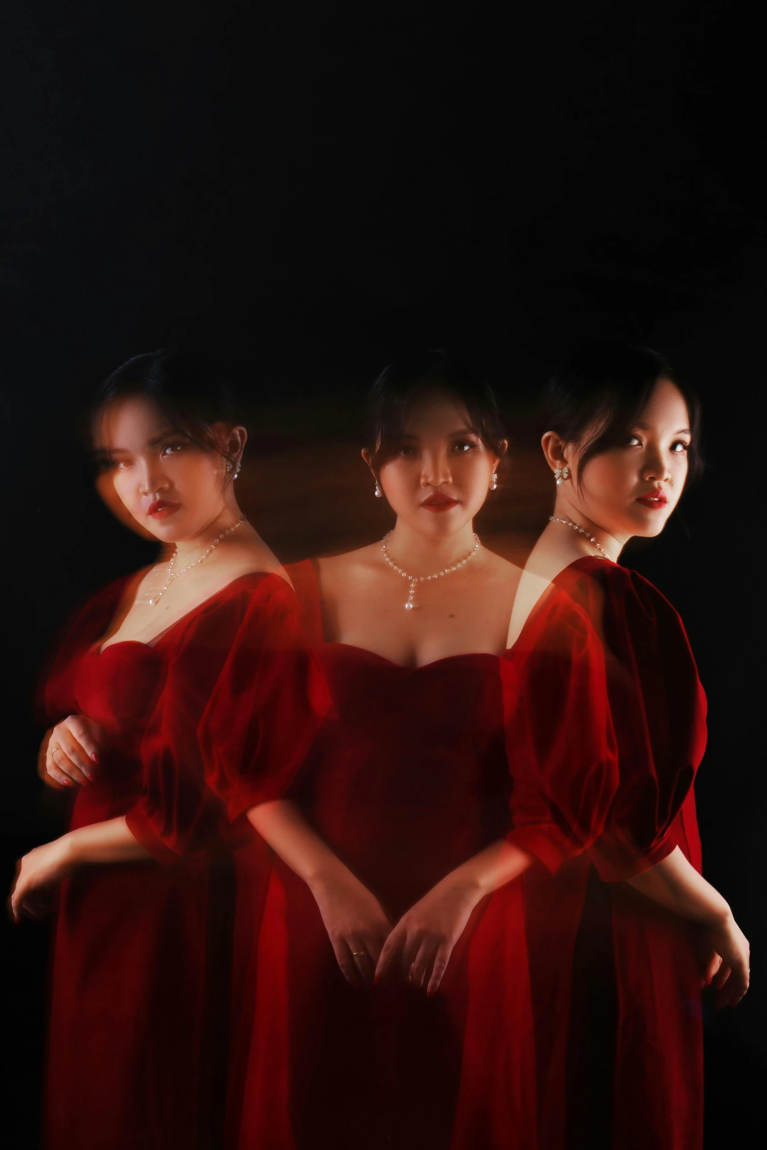 three women in red dresses standing next to each other, an album cover, by Shang Xi, hyperrealism, ethereal glow, 奈良美智, mirrored, portrait shot 8 k