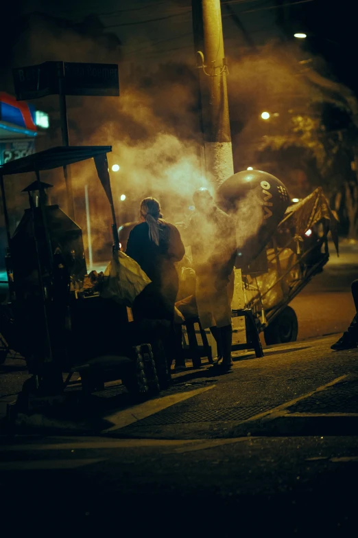 a group of people standing around a fire hydrant, by Matt Stewart, pexels contest winner, dark city bus stop, cooking it up, cuba, smokey cannons