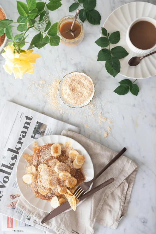 a white plate topped with bananas next to a cup of coffee, inspired by Richmond Barthé, renaissance, stroopwaffel, powdered sugar, flatlay, summer feeling