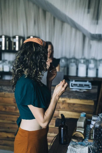 a couple of women standing in front of a counter, unsplash, curly brown hair, lush vista, serving body, inspect in inventory image