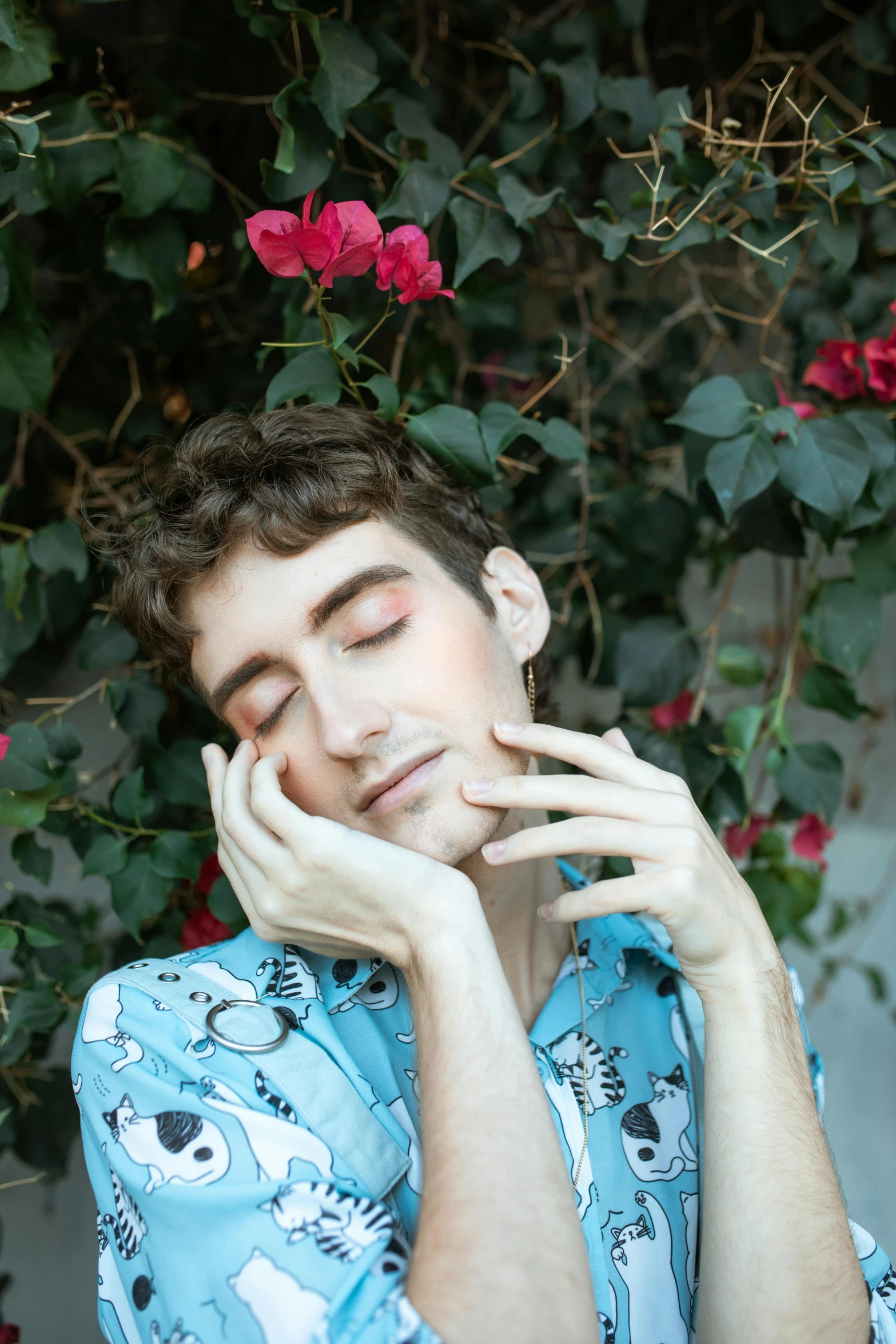 a man that is laying down with his eyes closed, an album cover, trending on pexels, aestheticism, robert sheehan, flowers on heir cheeks, hand on his cheek, non binary model