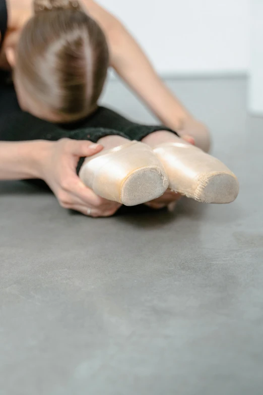 a woman in a black leo leo leo leo leo leo leo leo leo leo leo leo leo, inspired by Elizabeth Polunin, pexels contest winner, arabesque, gum rubber outsole, sitting on the floor, sculpting, slippers