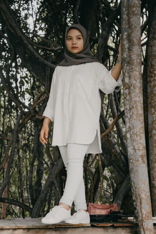 a woman standing on top of a wooden platform, inspired by Naza, unsplash, hurufiyya, wearing a linen shirt, white monochrome color!!!!!, foliage clothing, - 8