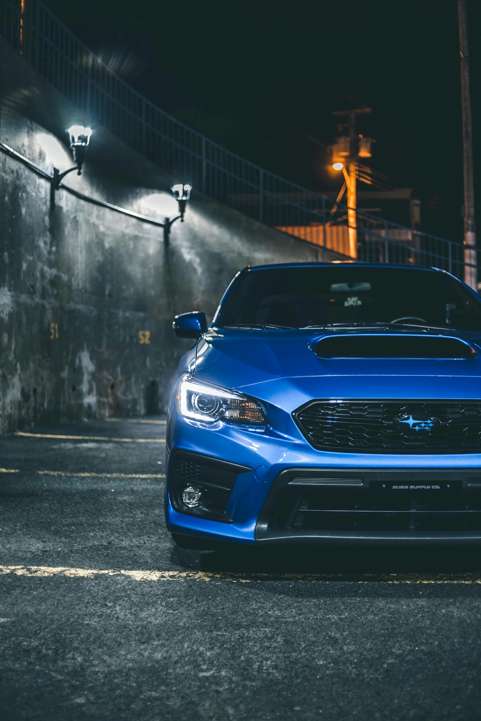 a blue subarunt parked in a parking lot at night, inspired by An Gyeon, close up portrait shot, low profile, trending photo, medium wide front shot