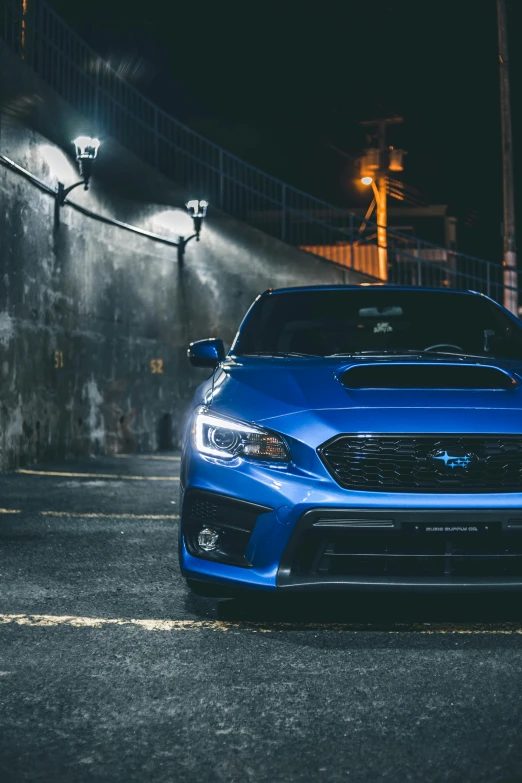 a blue subarunt parked in a parking lot at night, inspired by An Gyeon, close up portrait shot, low profile, trending photo, medium wide front shot