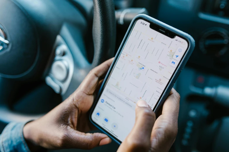 a person holding a cell phone in a car, by Carey Morris, pexels, square, map, mkbhd, 5k