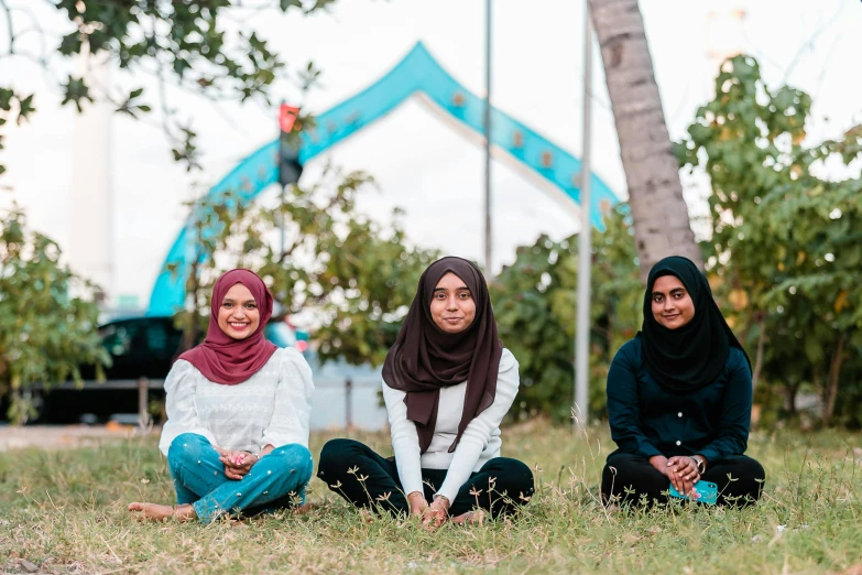 three women sitting on the grass in front of a tent, by Ella Guru, unsplash, hurufiyya, ameera al taweel, sitting under bridge, proud looking, profile image