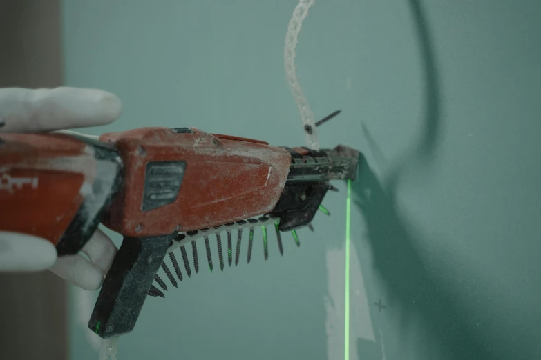 a close up of a person using a tool on a wall, cable wire implants, photorealistic movie still, laser sharp, promo image