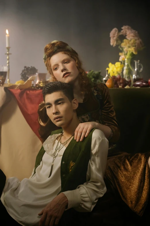 a couple of people sitting next to each other, an album cover, inspired by Georges de La Tour, trending on pexels, renaissance, young handsome pale roma, beautiful androgynous prince, movie still frame, preraphaelite