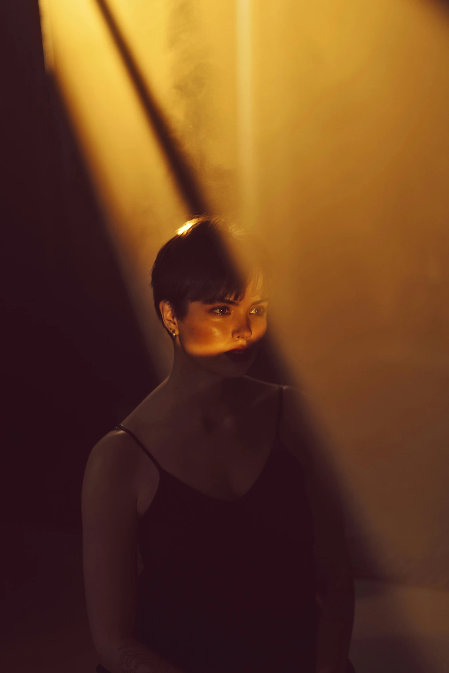 a woman sitting on a toilet in a dark room, a picture, by Adam Marczyński, pexels contest winner, portrait of natalie portman, standing under a beam of light, glowing yellow face, dark ballerina