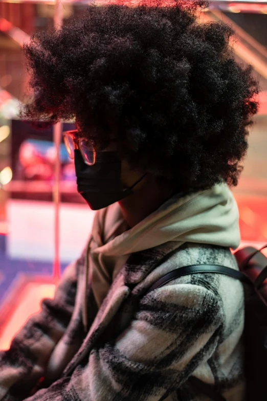 a woman with an afro wearing a face mask, by Dennis Flanders, lights on, gaming, multiple stories, tourist photo